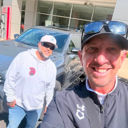 Justin and a customer beside a new ride at Toyota of Tacoma